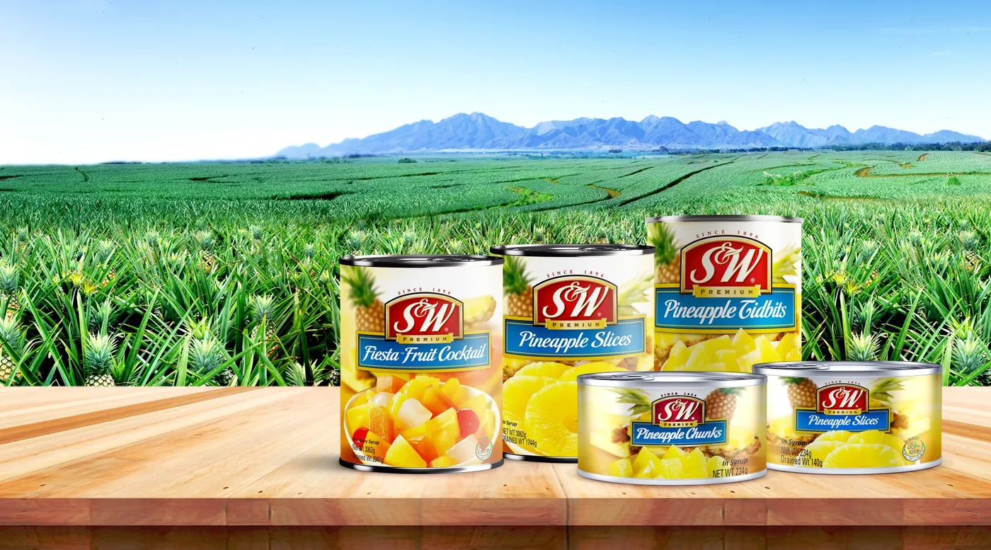 Cans of pineapple slices and fruit cocktail on a table